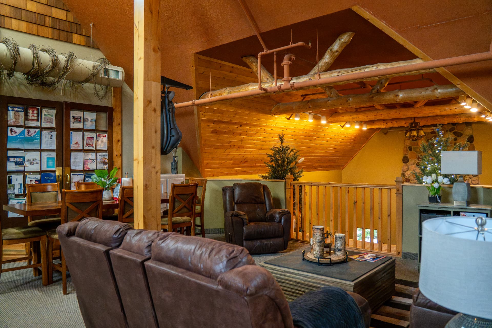 22. A wider view of the loft lounge, dining table and kitchenette.